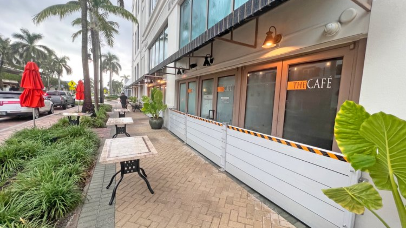 Exterior of a café featuring aluminum flood plank barriers in front of its windows, offering flood protection while maintaining the aesthetic of the building.