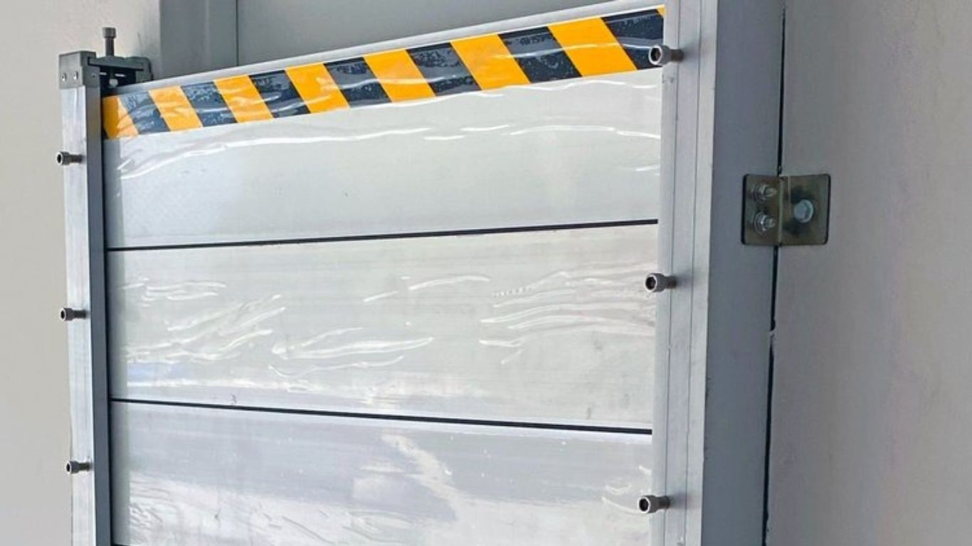 Mounted aluminum flood plank barrier showing reinforced stop-log panel design.